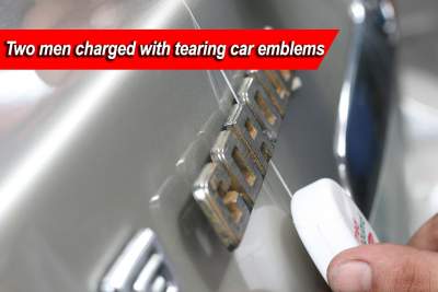 Two charged for removing car emblems
