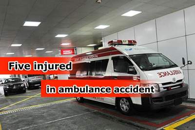 Five hurt in collision between ambulance and car