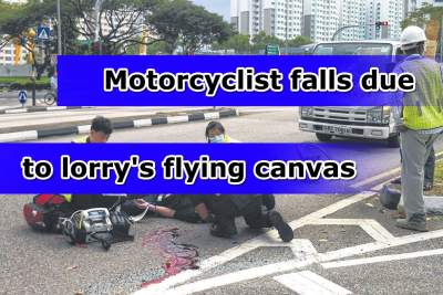 Motorcyclist loses control in heavy rain due to lorry's flying canvas