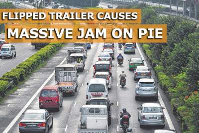 Large trailer flips on its side and causes PIE exit to be shut for 10 hours