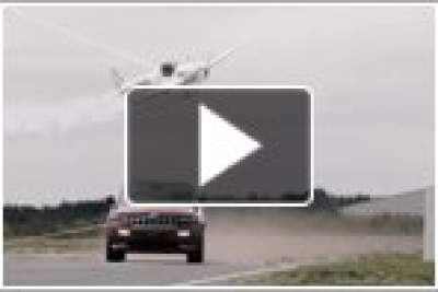 Jeep smokes plane in race around track
