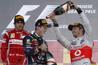 Vettel clinches title as Button wins in Japan