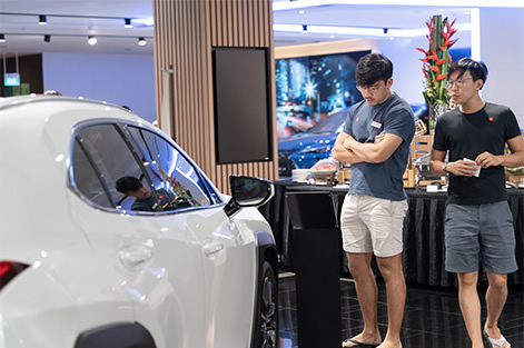 2 guy looking at white car
